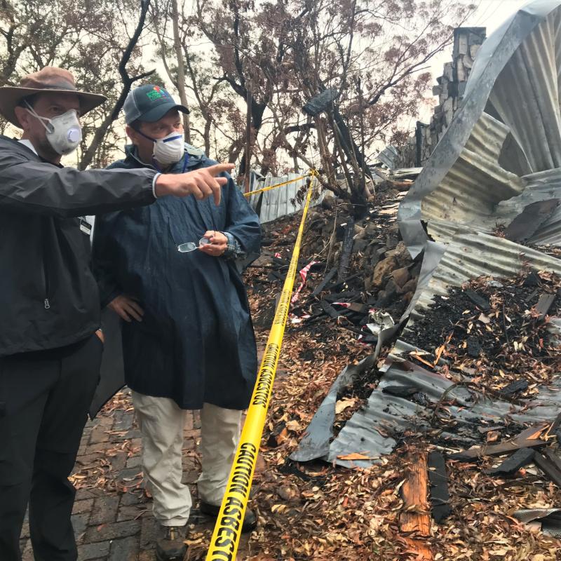 Binna Burra Lodge Chair Steve Noakes (r) surveys damage following the bushfires of 2019.